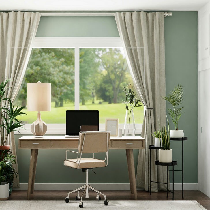 Home office junto a la ventana, con paredes de color verde menta